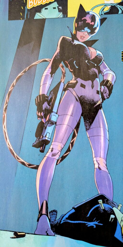 Absolute Catwoman holding a tranquilizing standing over a a body shot with several tranquilizing  darts.