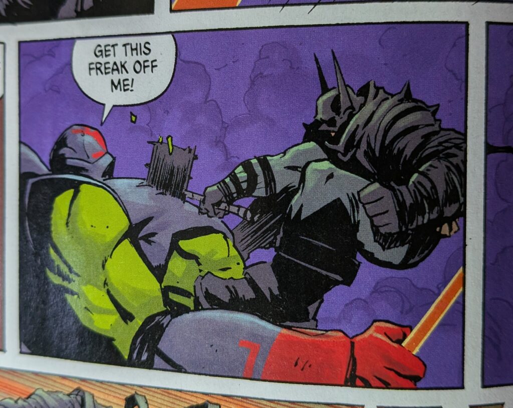 Absolute Batman with his axe buried in the chest of the green Absolute Robin's chest.