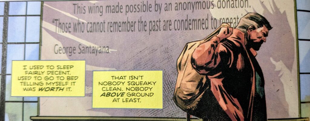 Absoltue Hawkman walks in front of a plaque in his street close while casting a shadow behind him in the shape of Absoltue Hawkman.