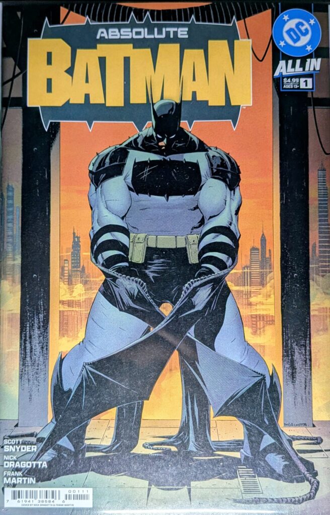 Absolute Batman #1 comic book cover A first print by Dragotta. Absolute Batman stands large in front of a Gotham backdrop with an orange sky.