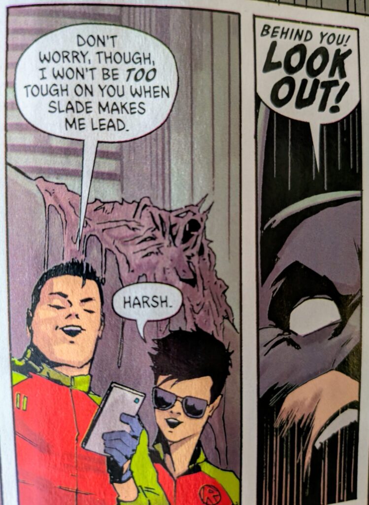Absolute Robins, Jason and Tim, gloat about catching Absolute Batman to Tim on a video call while Absolute Batman tries to warn them of Absoltue Clayface forming behind them.